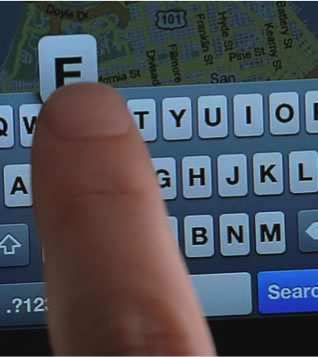 a persons finger shown typing on iphone keyboard covering most of the visible buttons